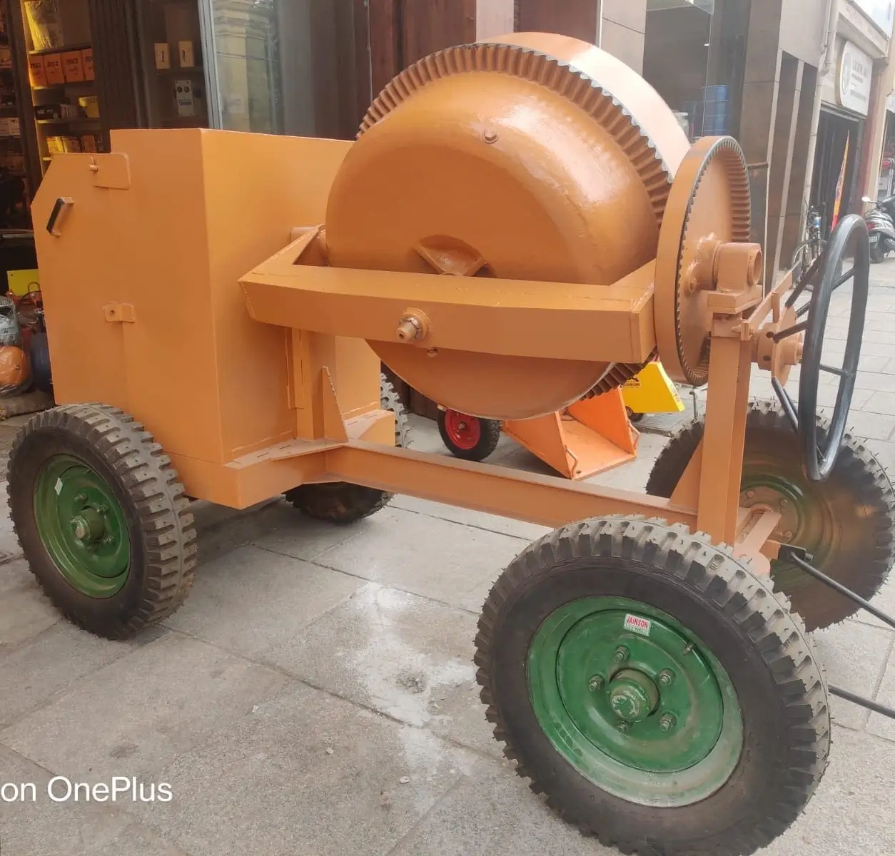 Concrete mixer front view showing 560L tilting drum and Kirloskar engine assembly