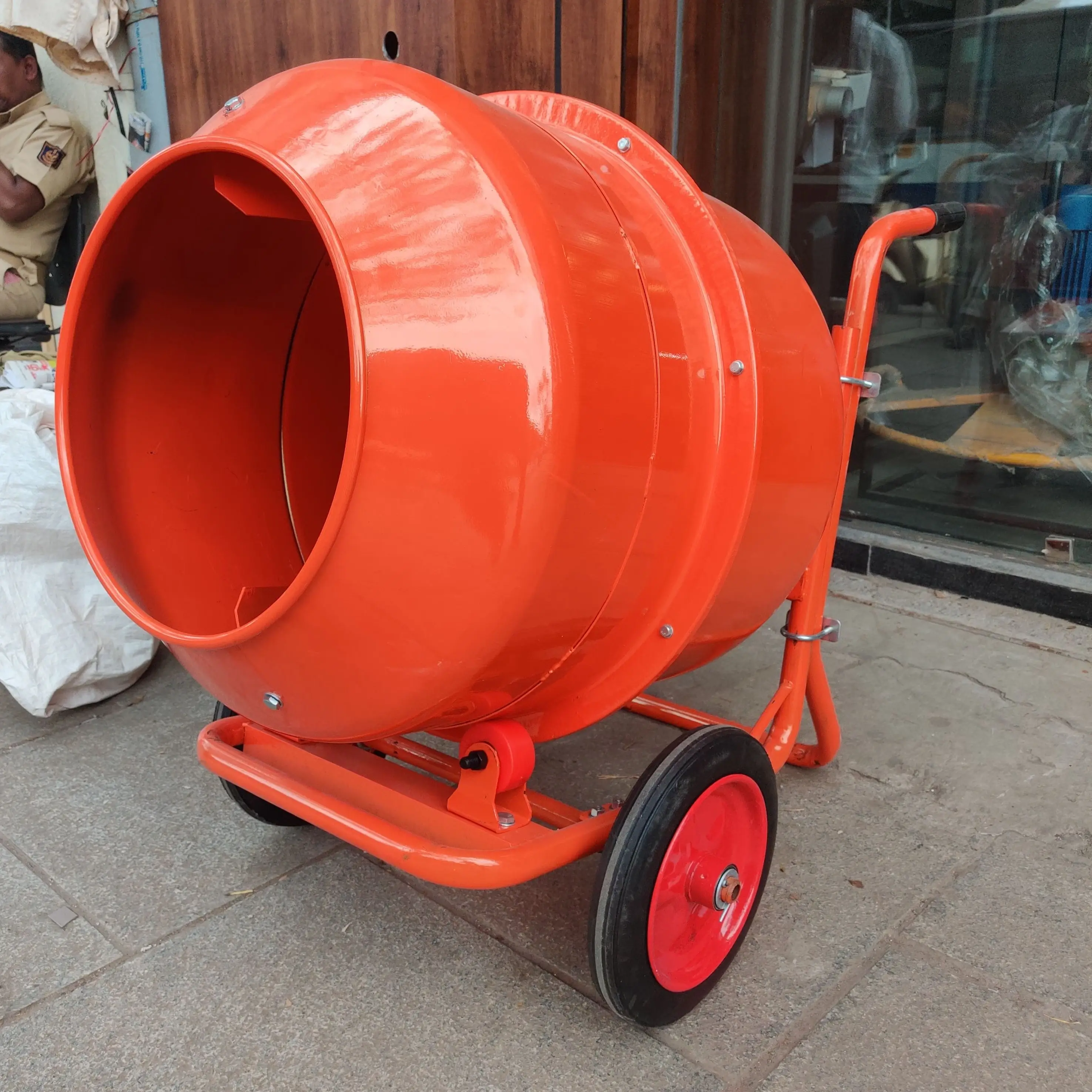 Close-up detail view of concrete mixer tilting mechanism and discharge system