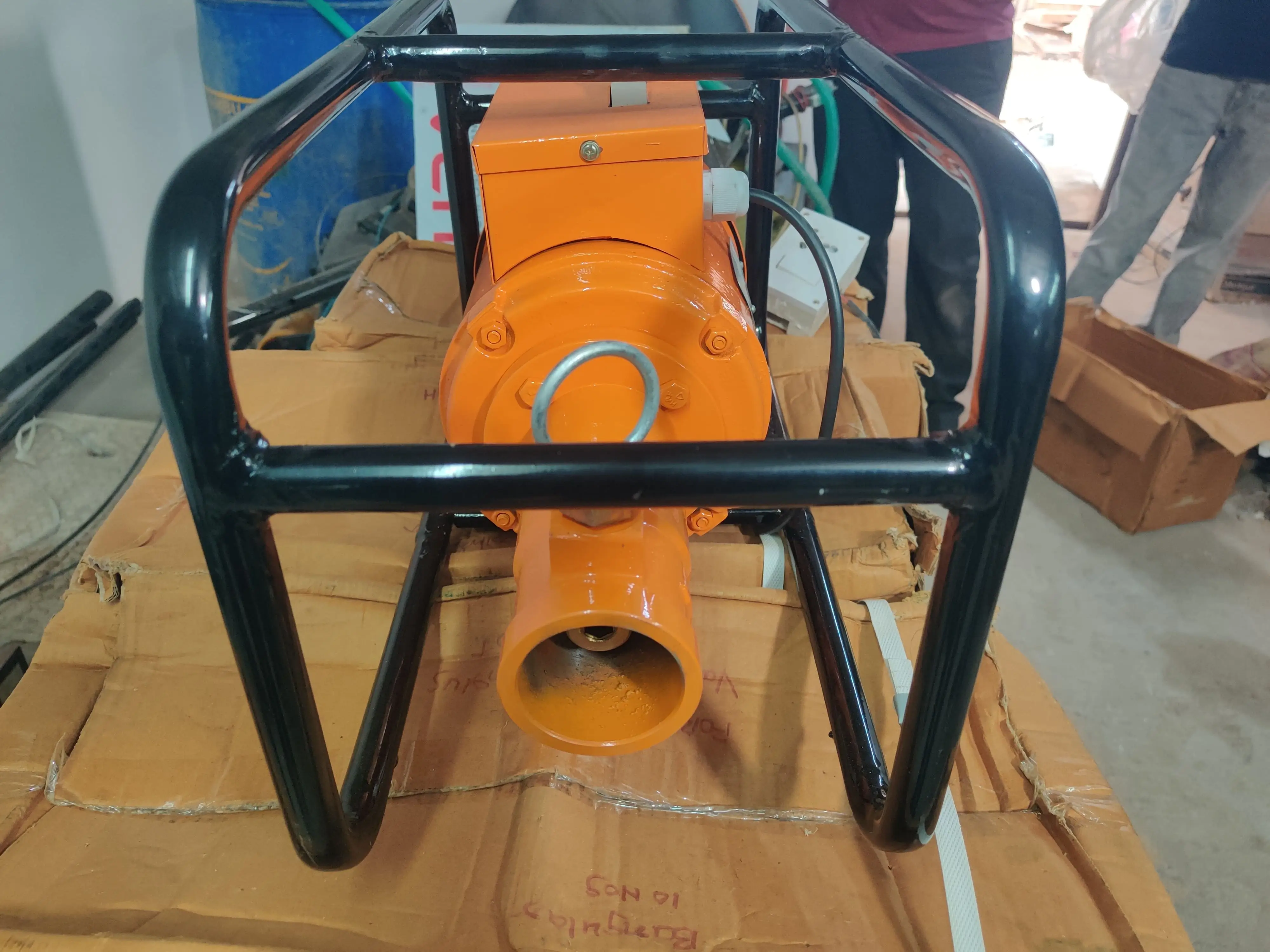 Close-up detail view of concrete vibrator needle head and shaft assembly