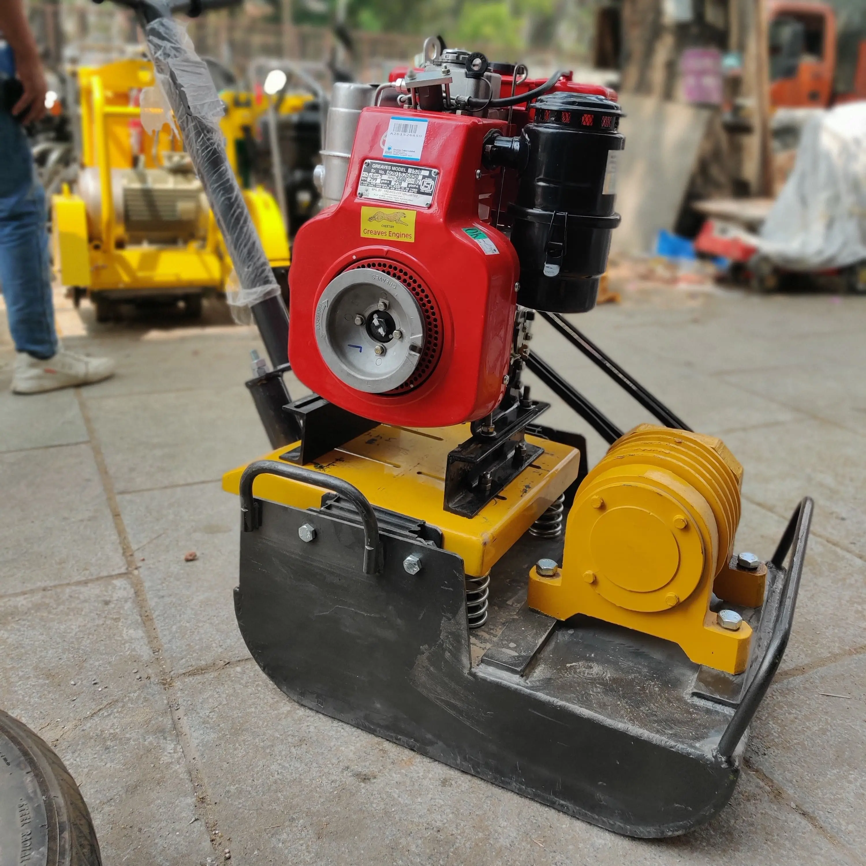 Plate compactor being used for trench compaction in utility installation