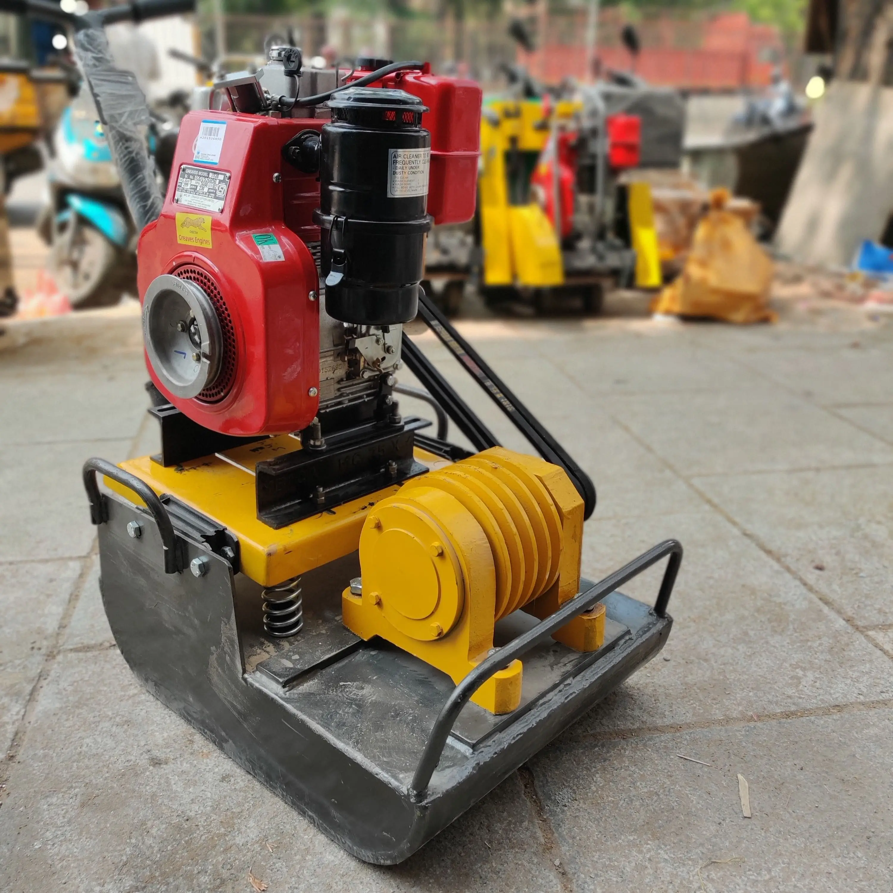 Vibratory plate compactor preparing base layer for paver installation